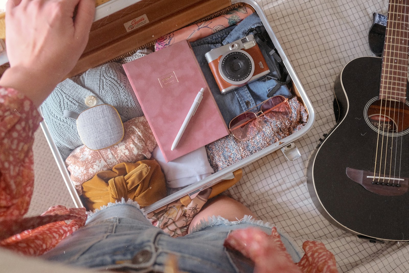 Person packing a small suitcase