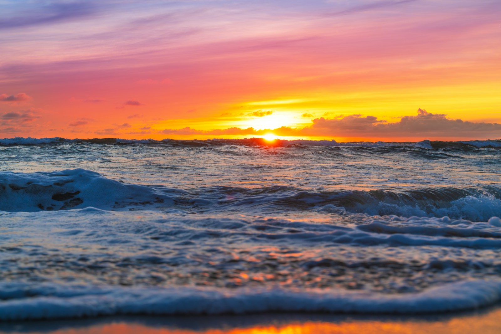 A serene beach at sunset with colorful sky