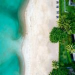 An aerial view of a beach with a house on it