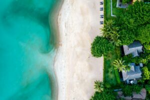 An aerial view of a beach with a house on it