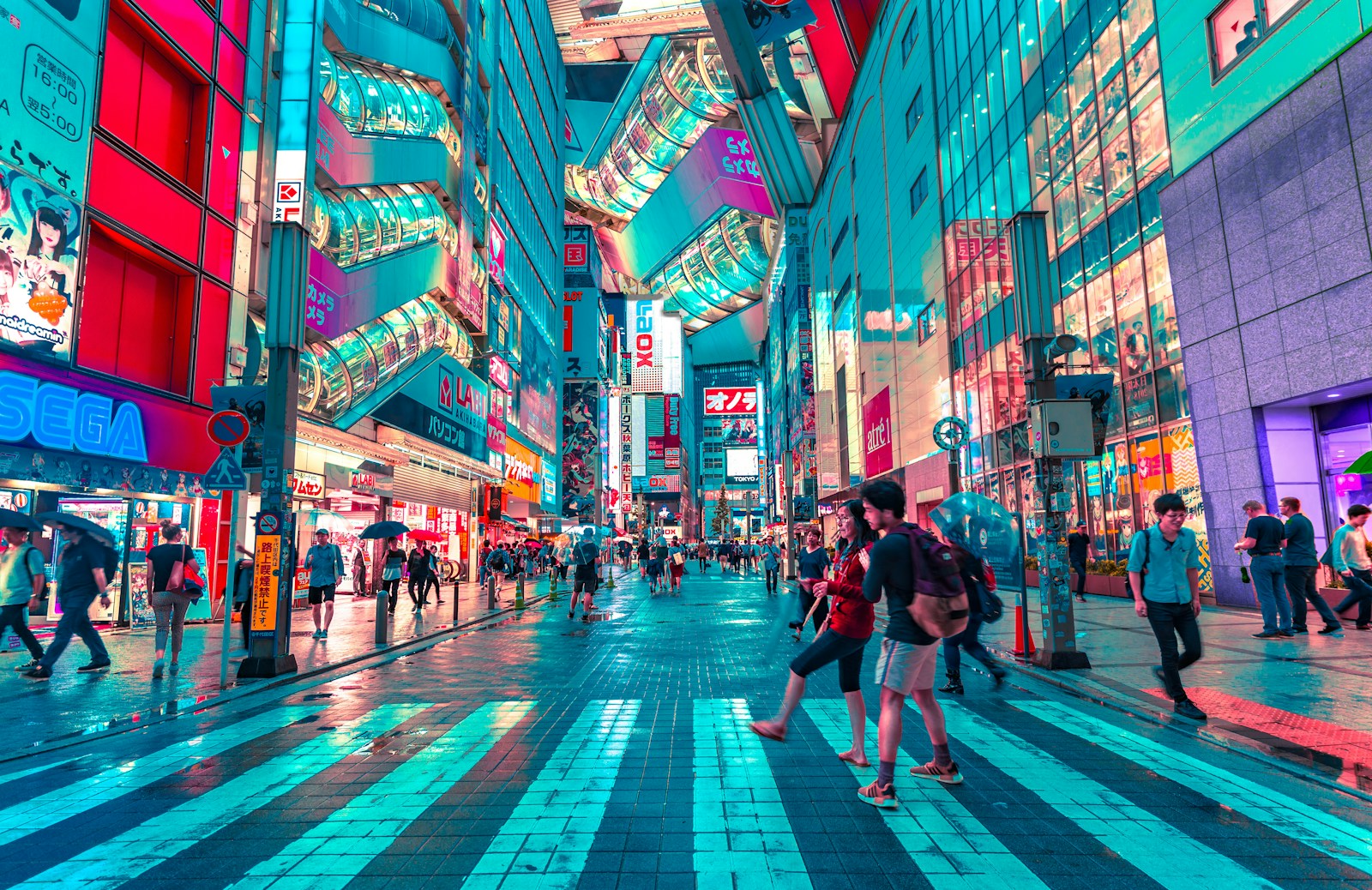 people walking on road near well-lit buildings