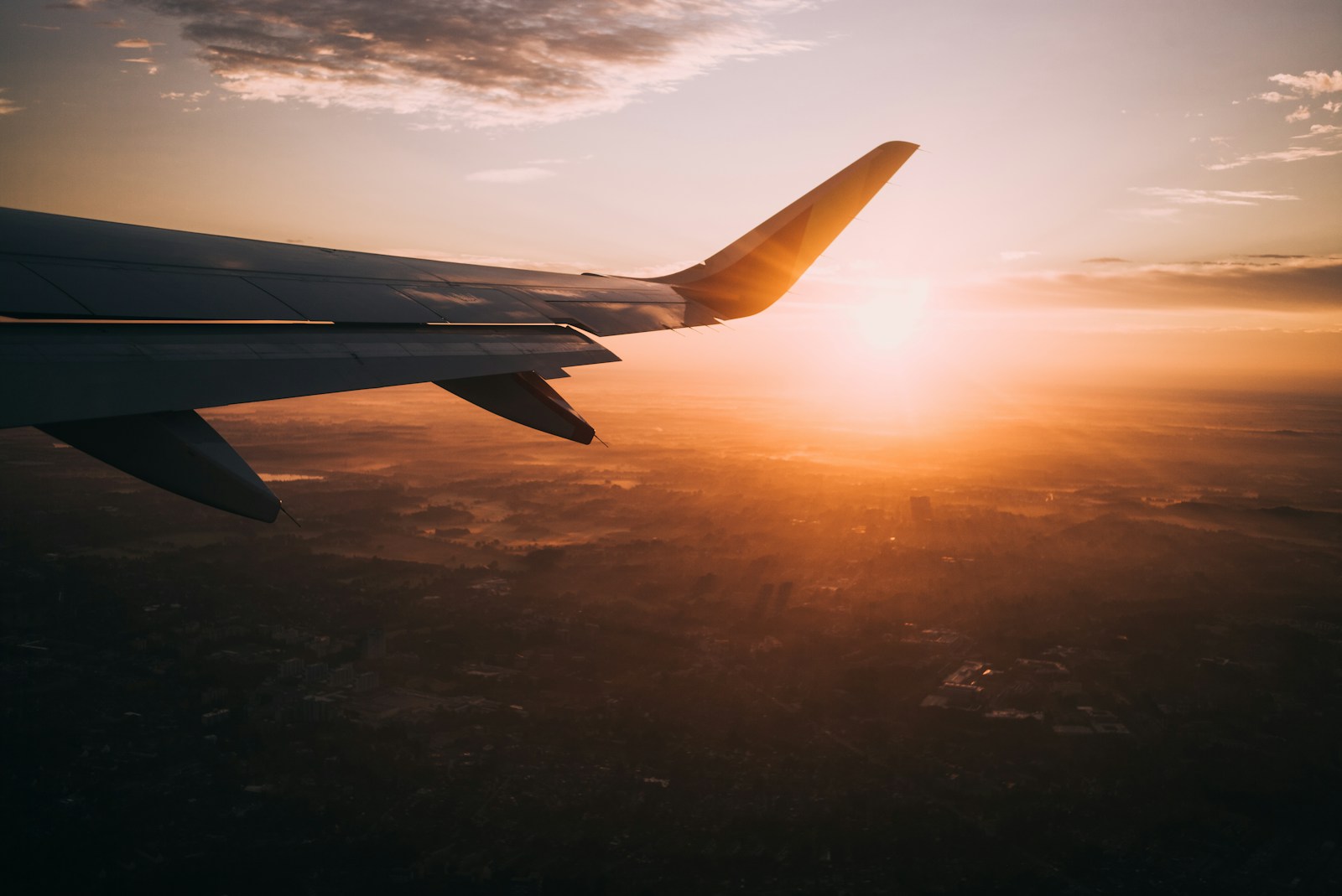 Budget-friendly travel destinations airplane on sky during golden hour