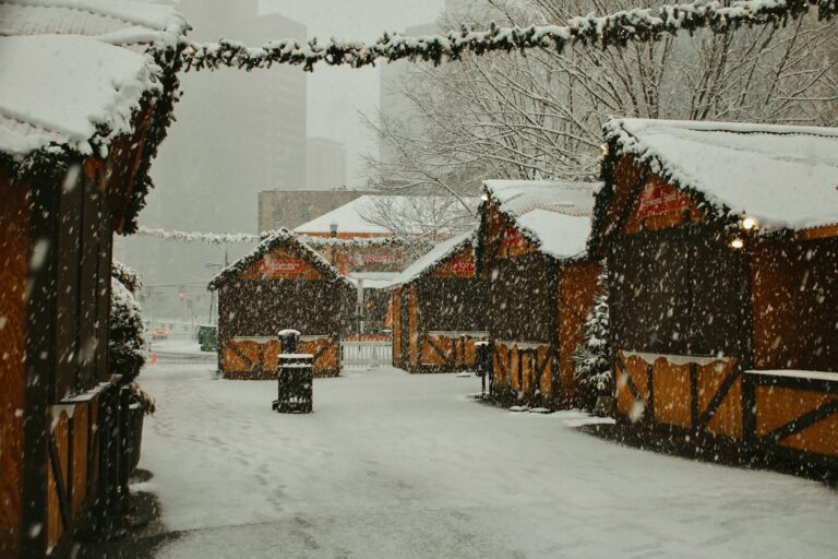 a snowy street lined with wooden buildings