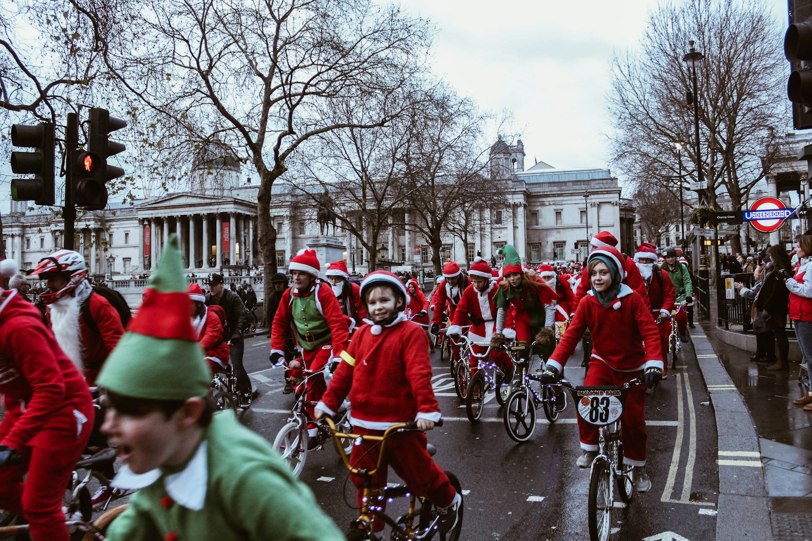 London's Christmas group of children in bicycle near white building